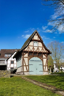Das Weseraquarium befindet sich in einem kleinen Fachwerkgebäude an der Weserpromenade mit gräulich brauner Fachwerkfassade und einem spitzen Dach. An der Front des Gebäudes befindet sich ein hellgrüne Holztor mit der Aufschrift „Weseraquarium“. An der Seite des Gebäudes sowie in der oberen Etage befinden sich Fenster.
Geleitet wird das Weseraquarium durch den gemeinnützigen Verein „Moby Dick“.&nbsp;&copy;&nbsp;Samtgemeinde Bodenwerder-Polle - Rolf Sander